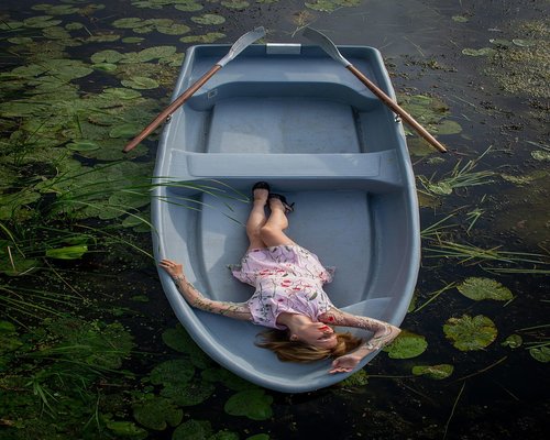 A person resting calmly on a bench in a natural park